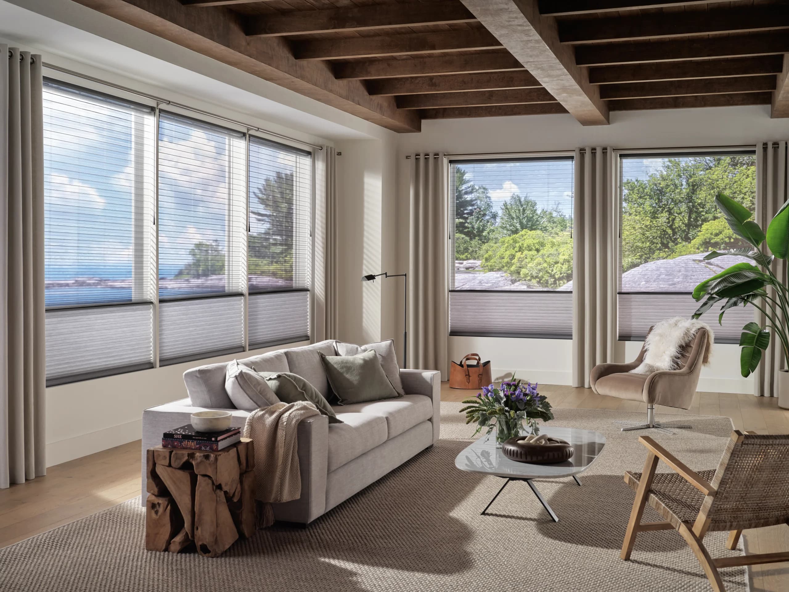 A dark, serene bedroom with blackout cellular shades holding back all but a thin edge of morning light.