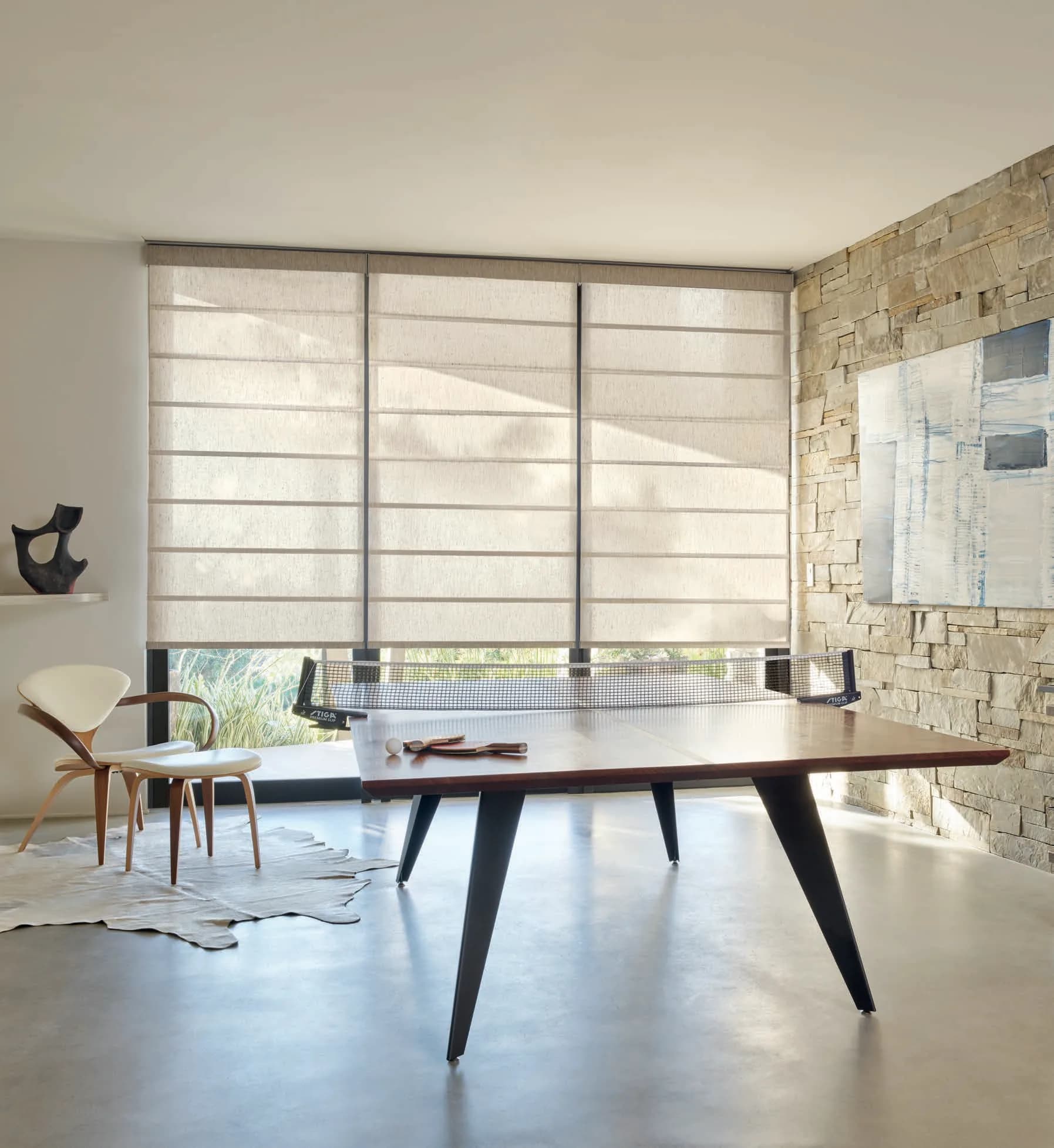 Alustra® Architectural Roller Shades in Hunter Douglas's Rumi fabric, color Moroccan Sand, operated with PowerView® Automation.