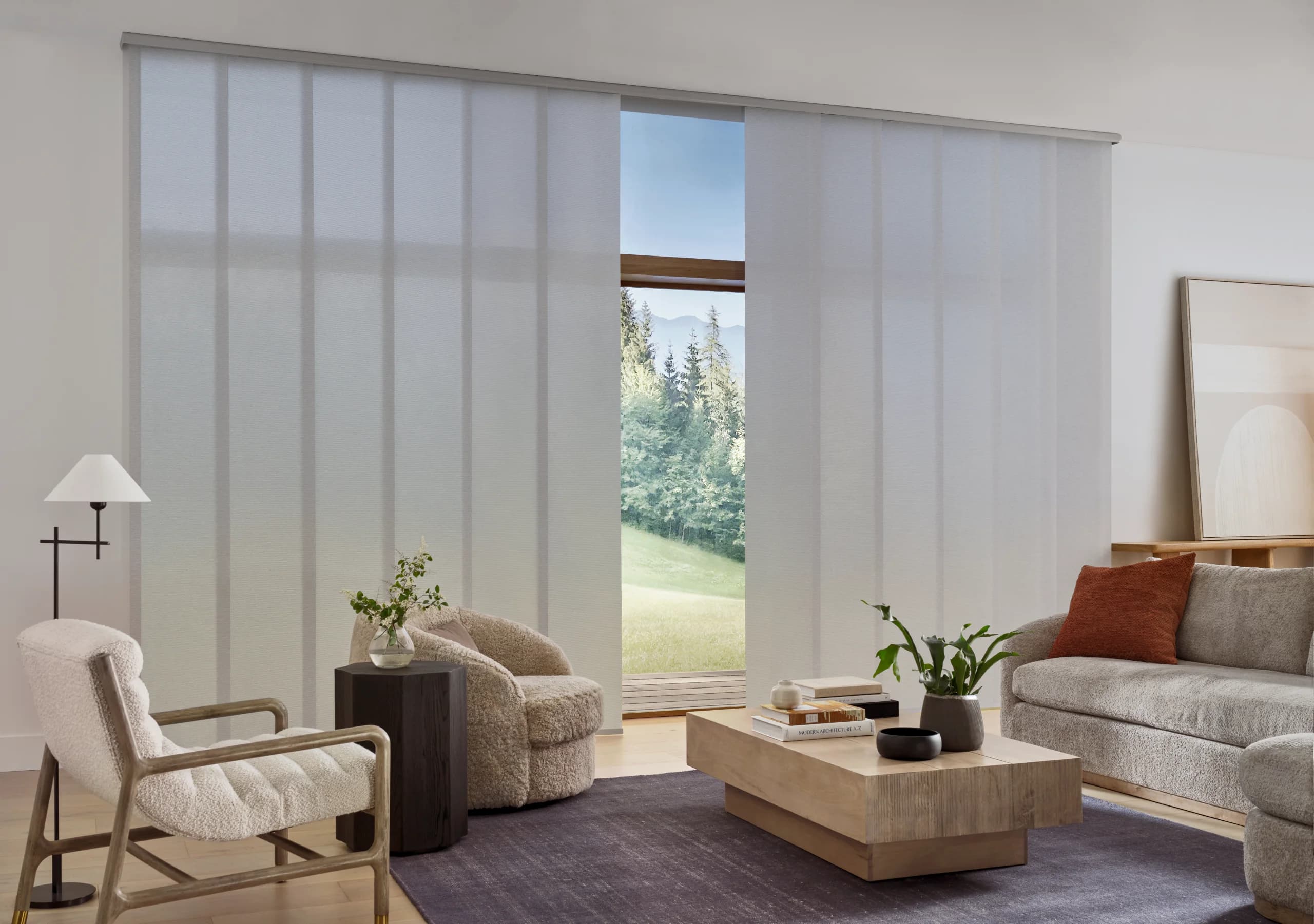 A Designer Screen Shade in a 1 percent openness fabric holding the view across a bright living room.