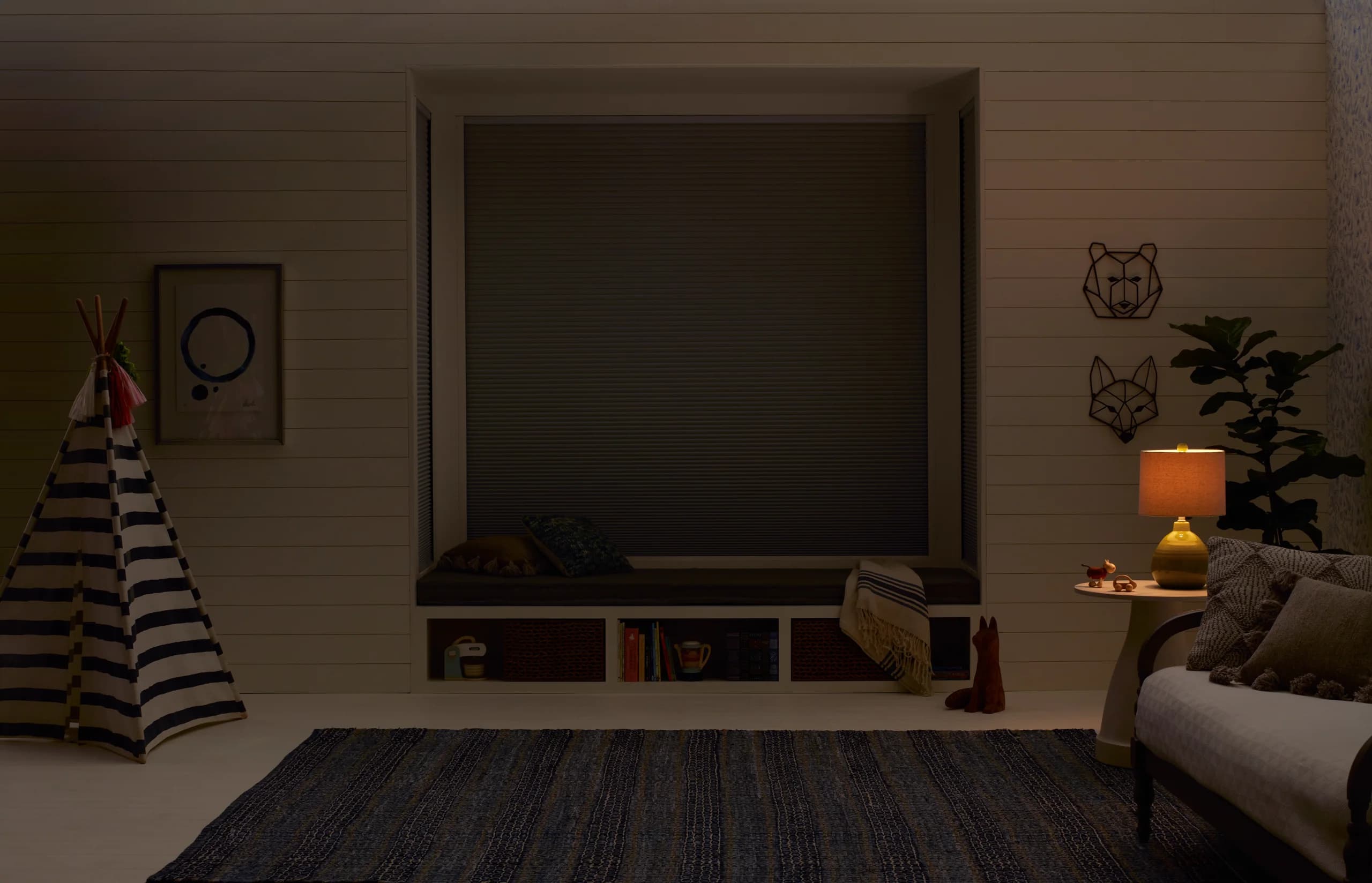 Hunter Douglas Duette® Honeycomb Shades with LightLock® closed across a child's bedroom window to darken the room.