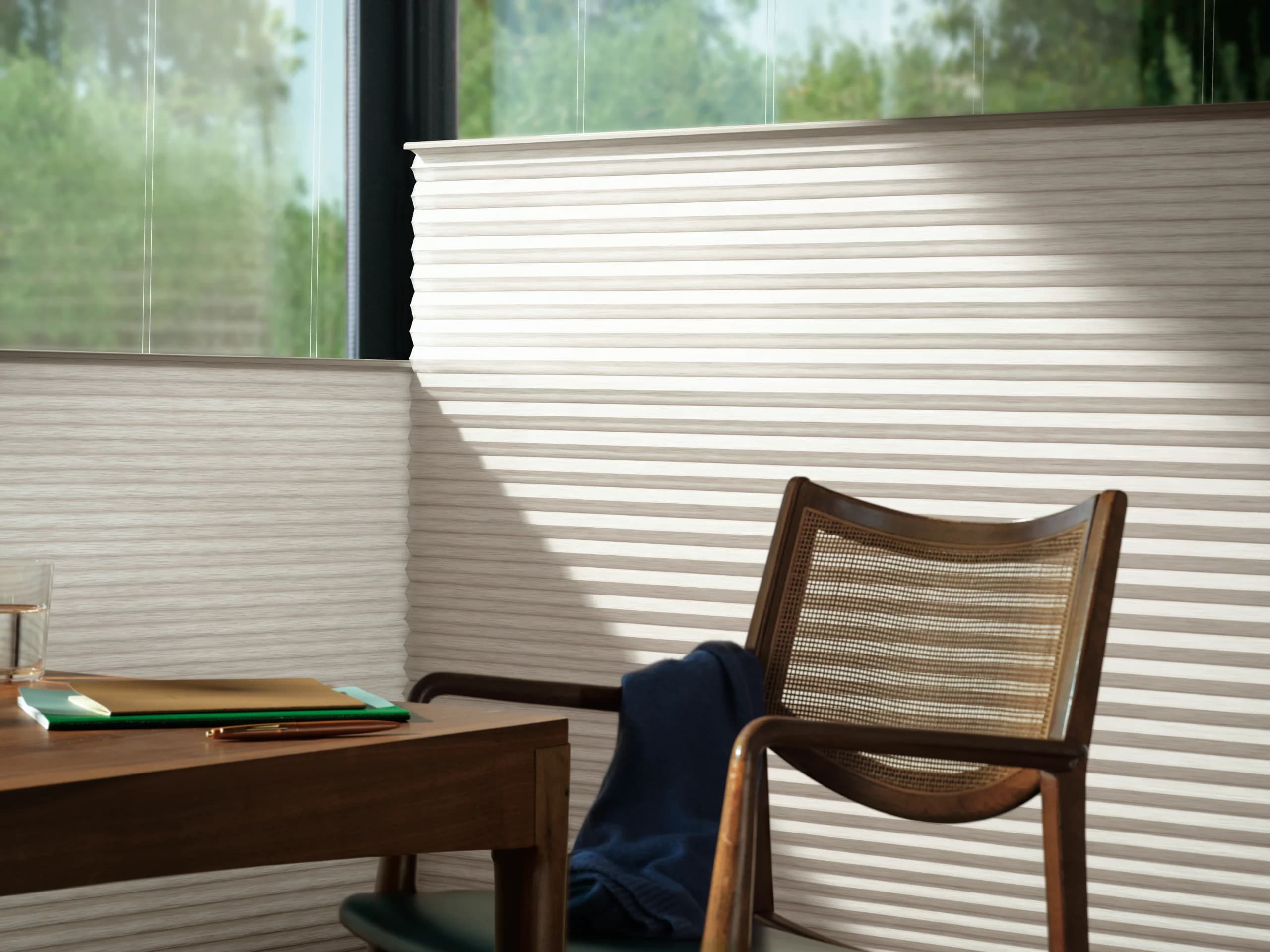 Close view of Hunter Douglas Duette® Honeycomb Shades in a Top-Down/Bottom-Up design at an office window.