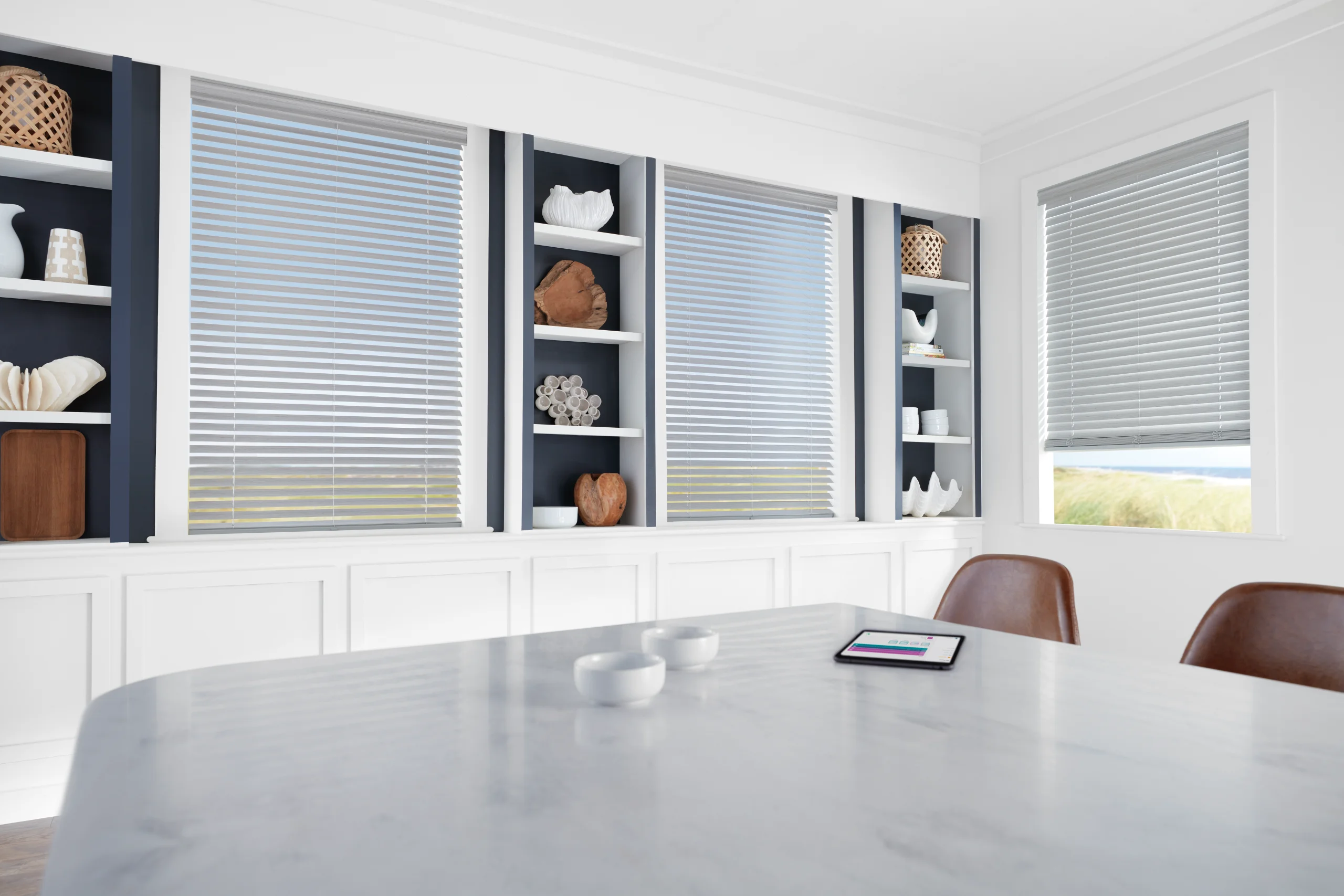 Hunter Douglas EverWood® Alternative Wood Blinds lowered over a kitchen window, slats tilted to cut the glare.