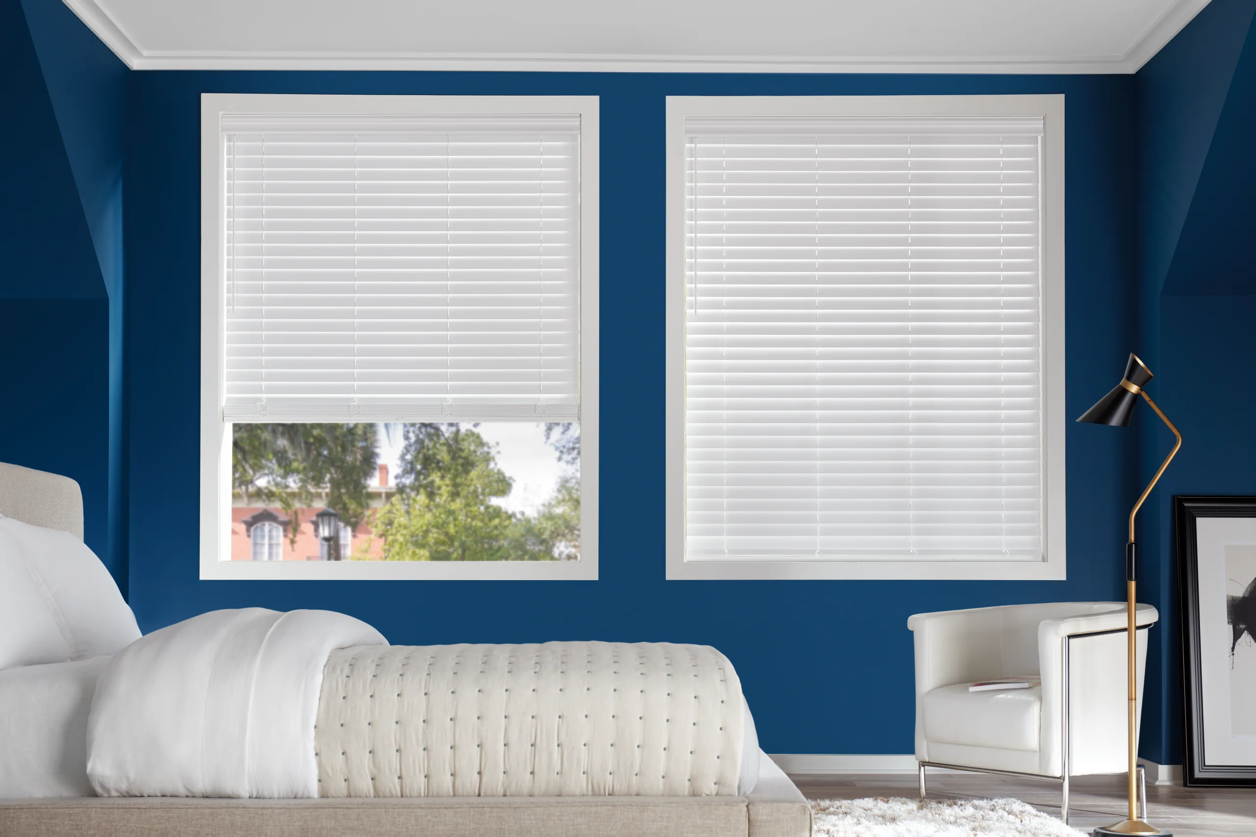 Hunter Douglas EverWood® Alternative Wood Blinds closed across a bedroom window for privacy.