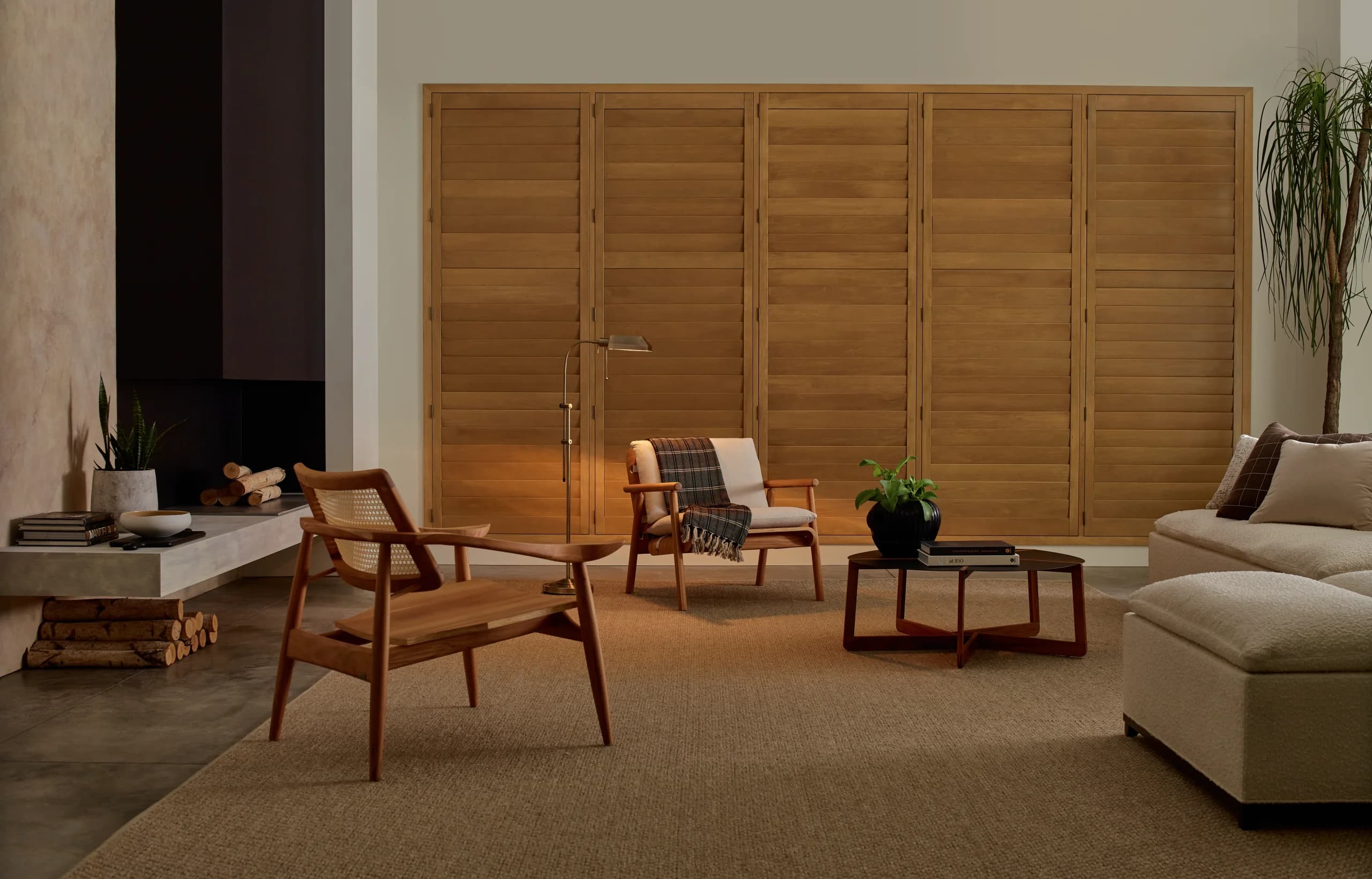 Hunter Douglas Heritance® Hardwood Shutters closed across a living room window for privacy.