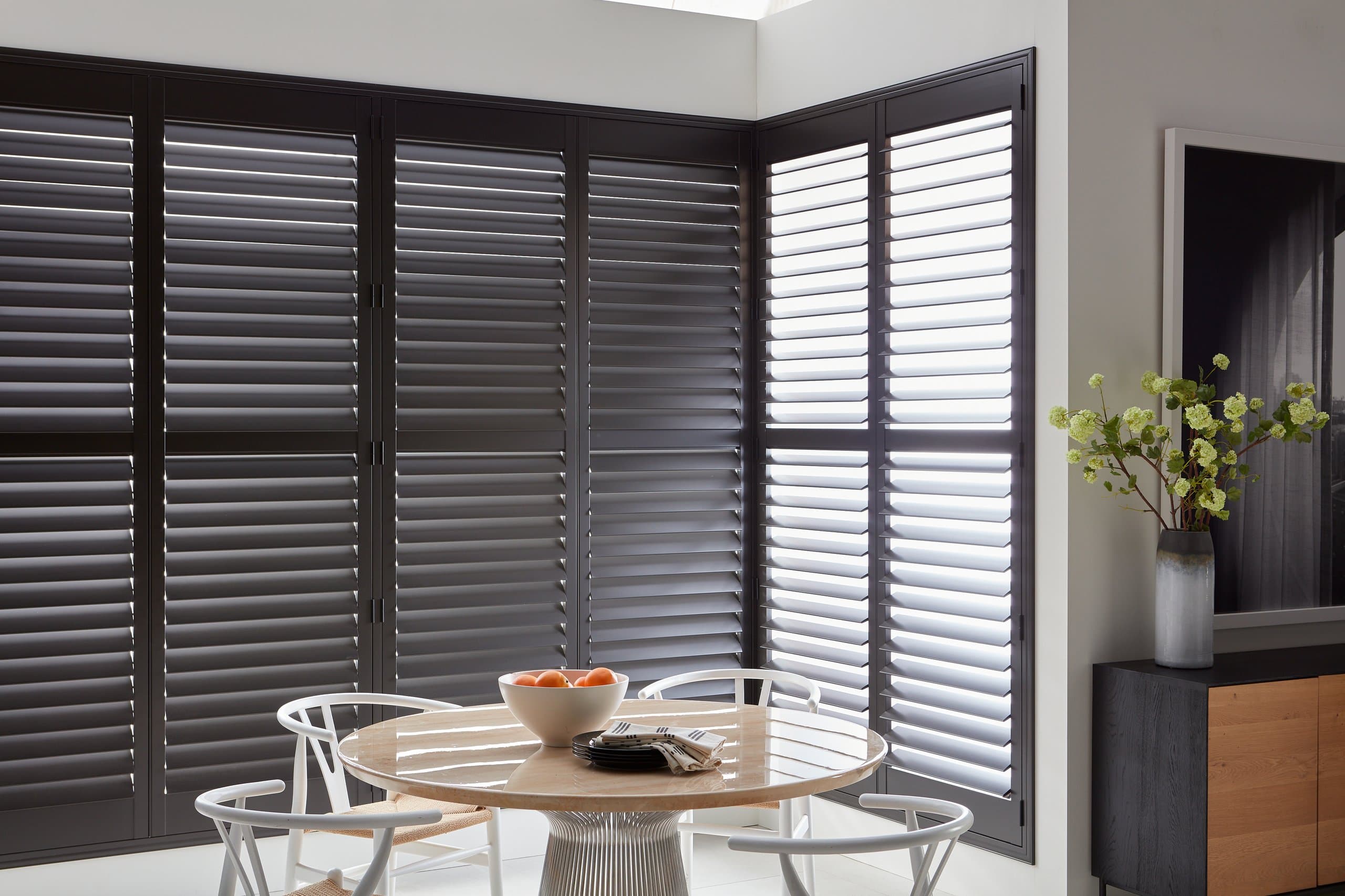 Hunter Douglas Heritance® Hardwood Shutters fitted to a corner window in a kitchen.