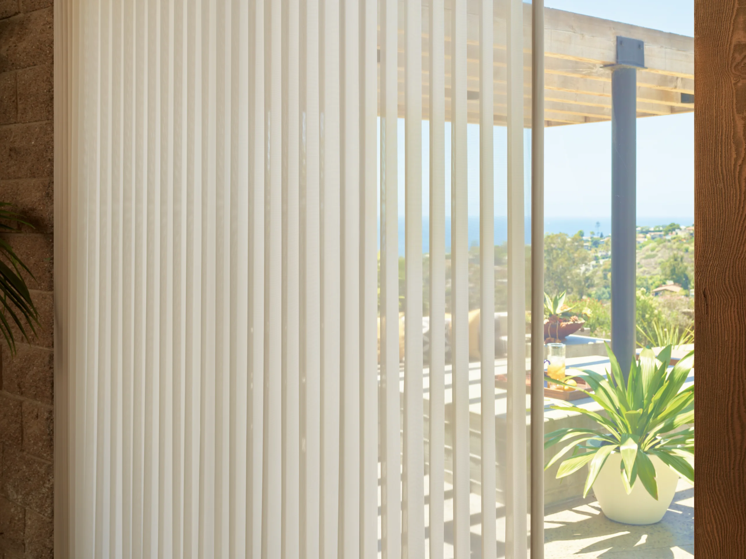 A detail of Hunter Douglas Luminette® Privacy Sheers, vertical vanes rotating to diffuse the light.