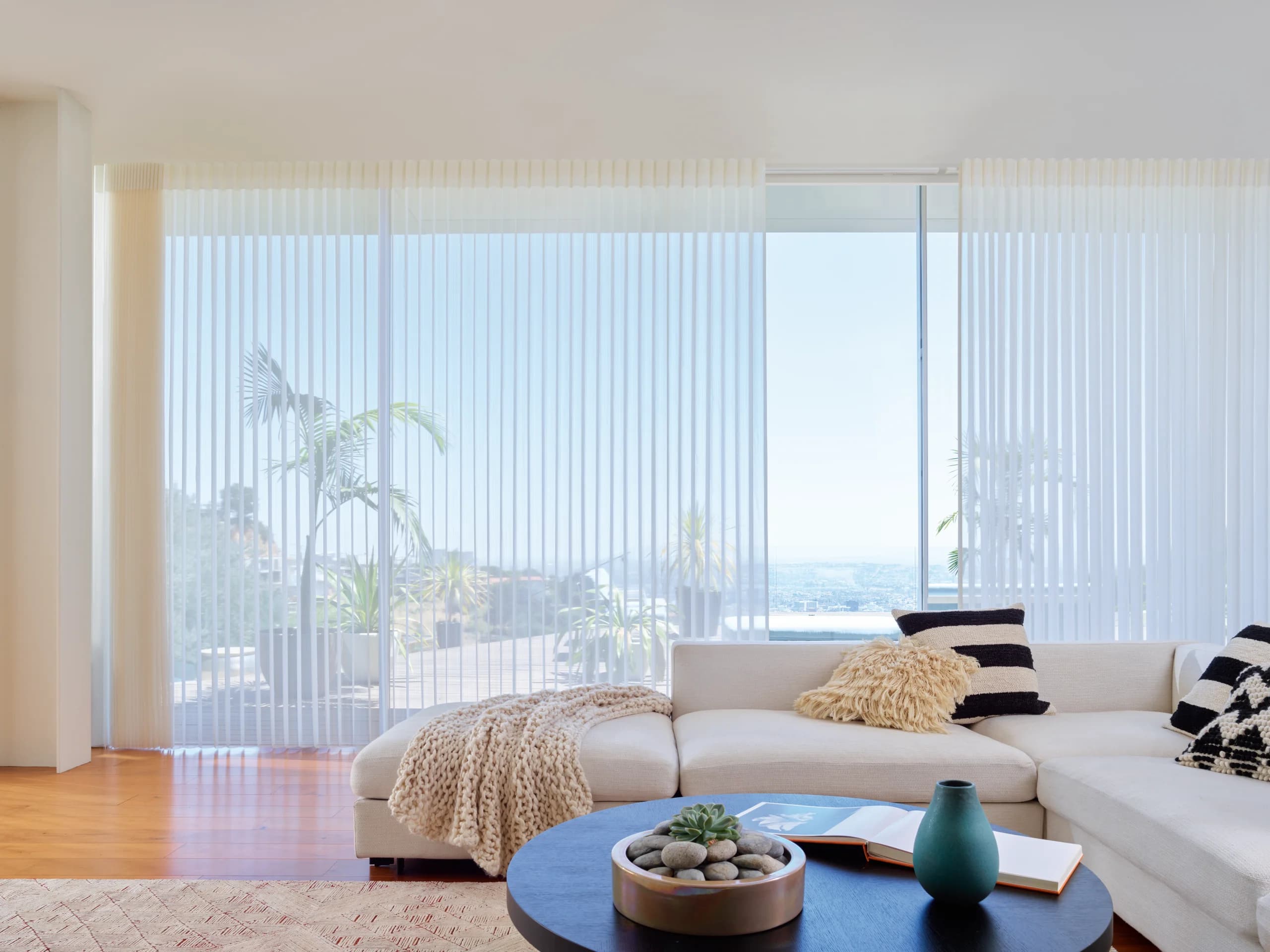 Hunter Douglas Luminette® Privacy Sheers hanging like drapery along a living room window wall.