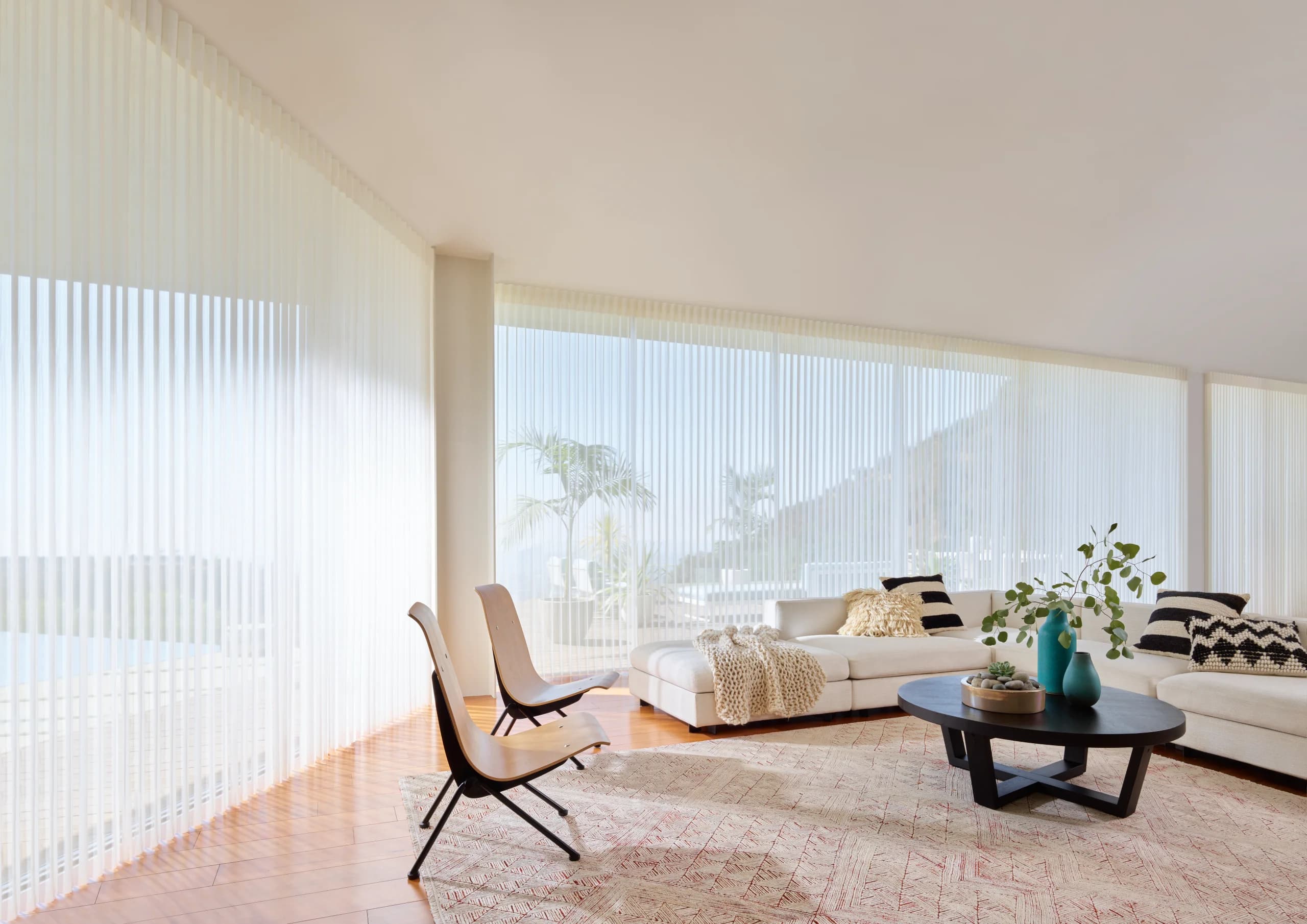 Hunter Douglas Luminette® Privacy Sheers traversed fully closed across a living room slider.