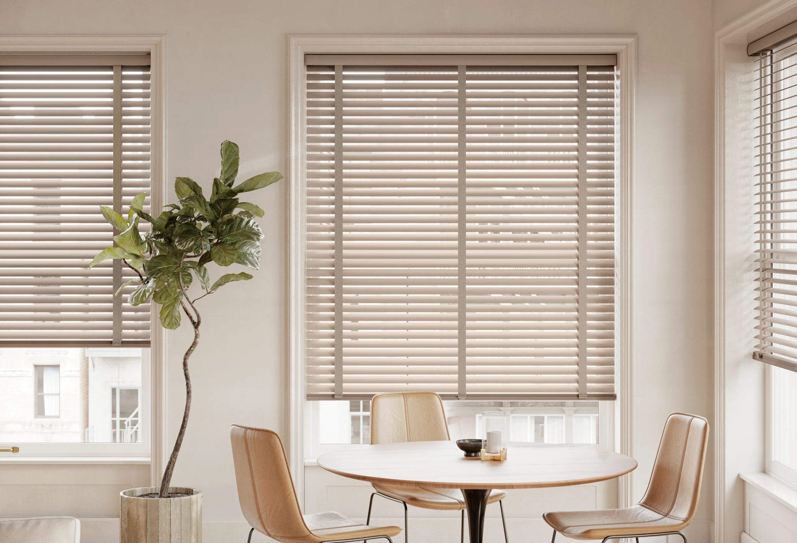 Hunter Douglas Modern Precious Metals® Aluminum Blinds in a soft taupe with decorative tapes on a dining room window.
