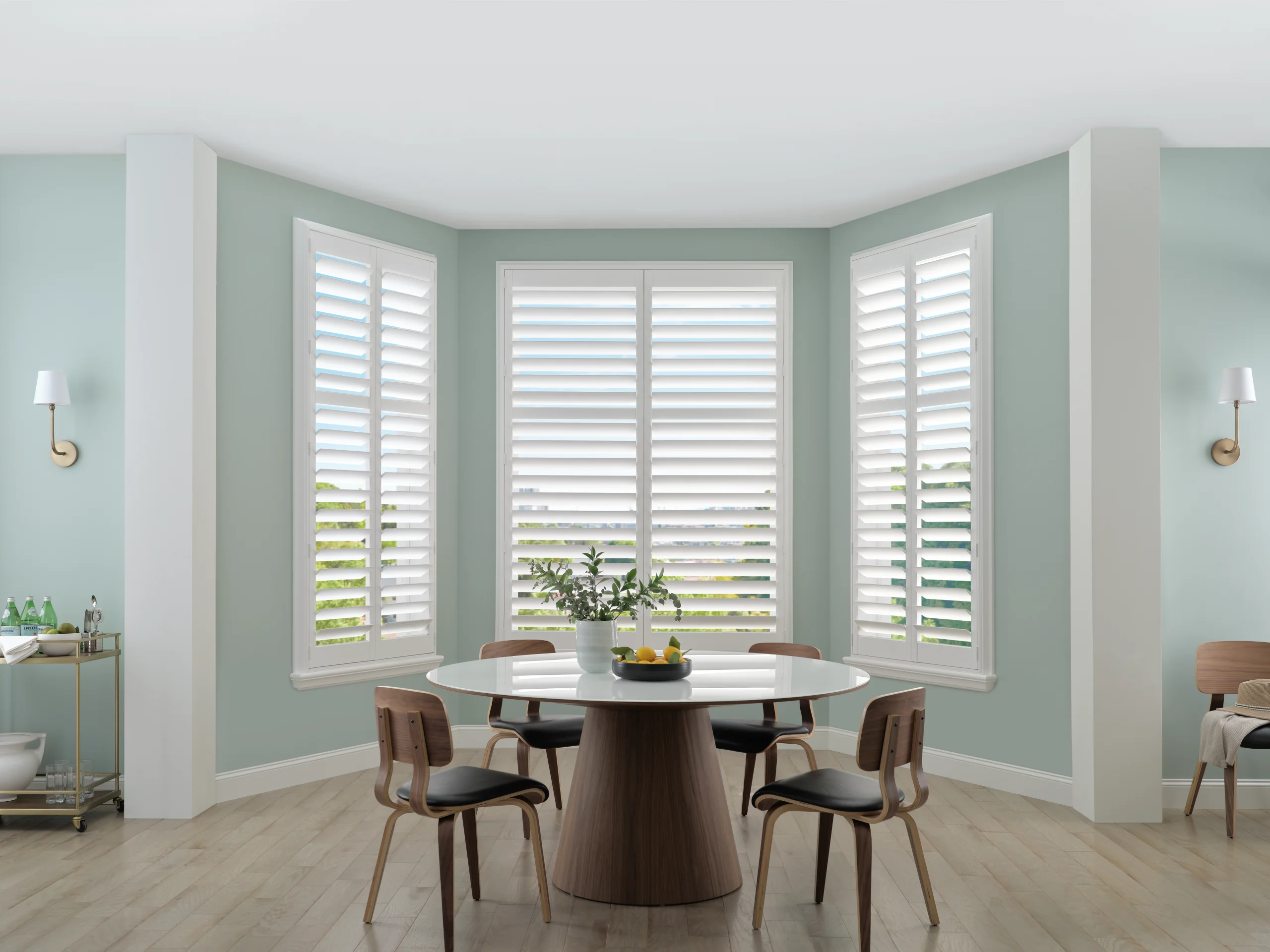 Hunter Douglas Palm Beach™ Polysatin™ Shutters across a bay of dining room windows with every panel closed.