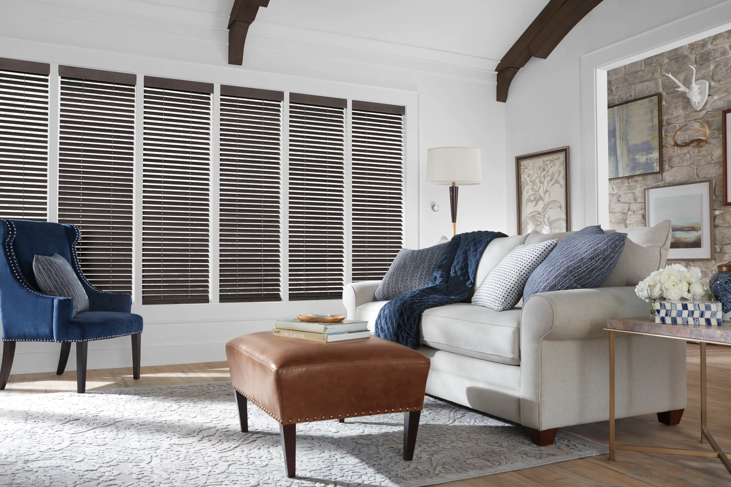 Hunter Douglas Parkland® Wood Blinds in a dark stain, tilted across a six panel window wall in a beamed living room.