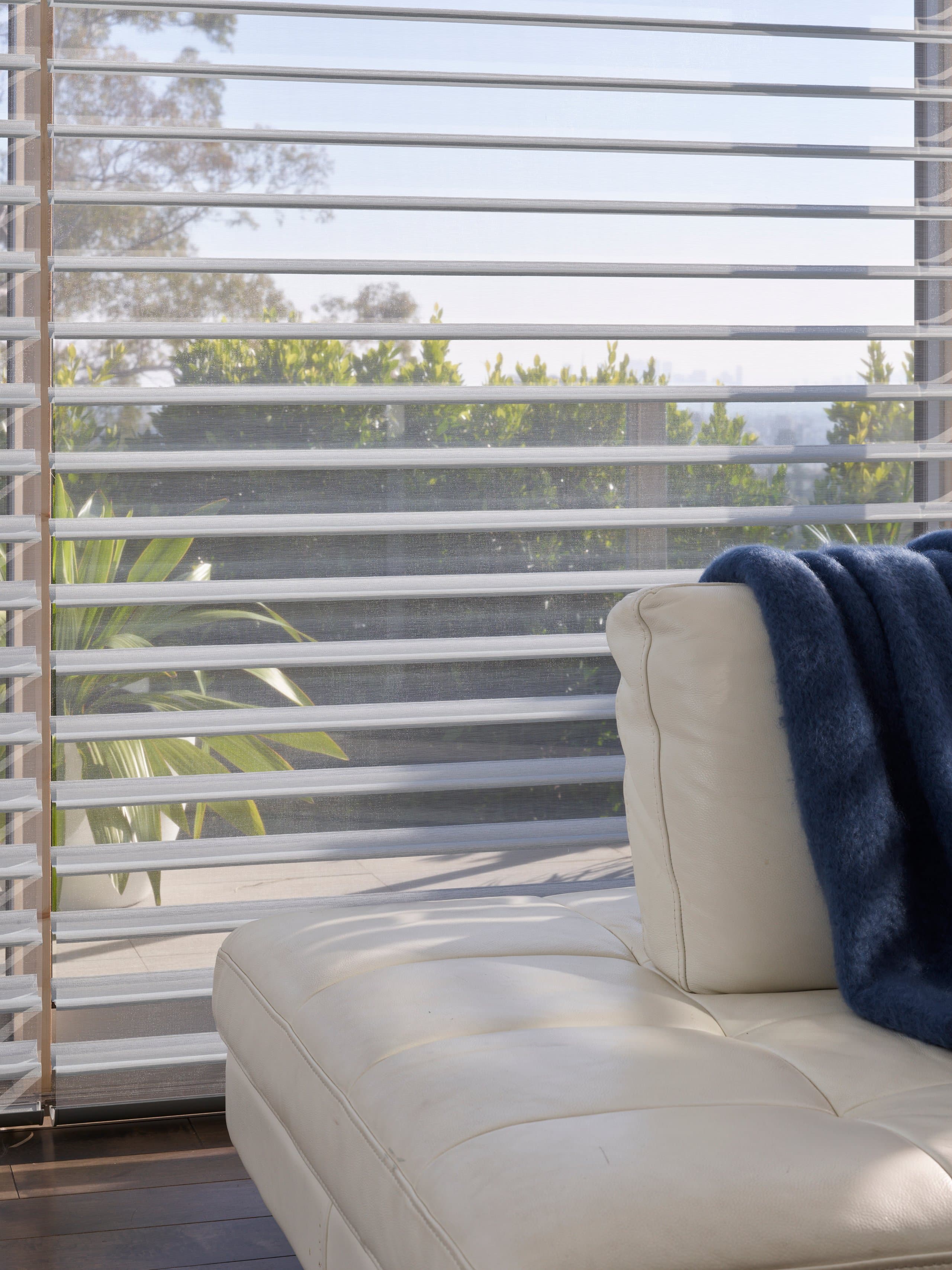 Hunter Douglas Silhouette® Window Shadings softening golden-hour light in a New England living room.