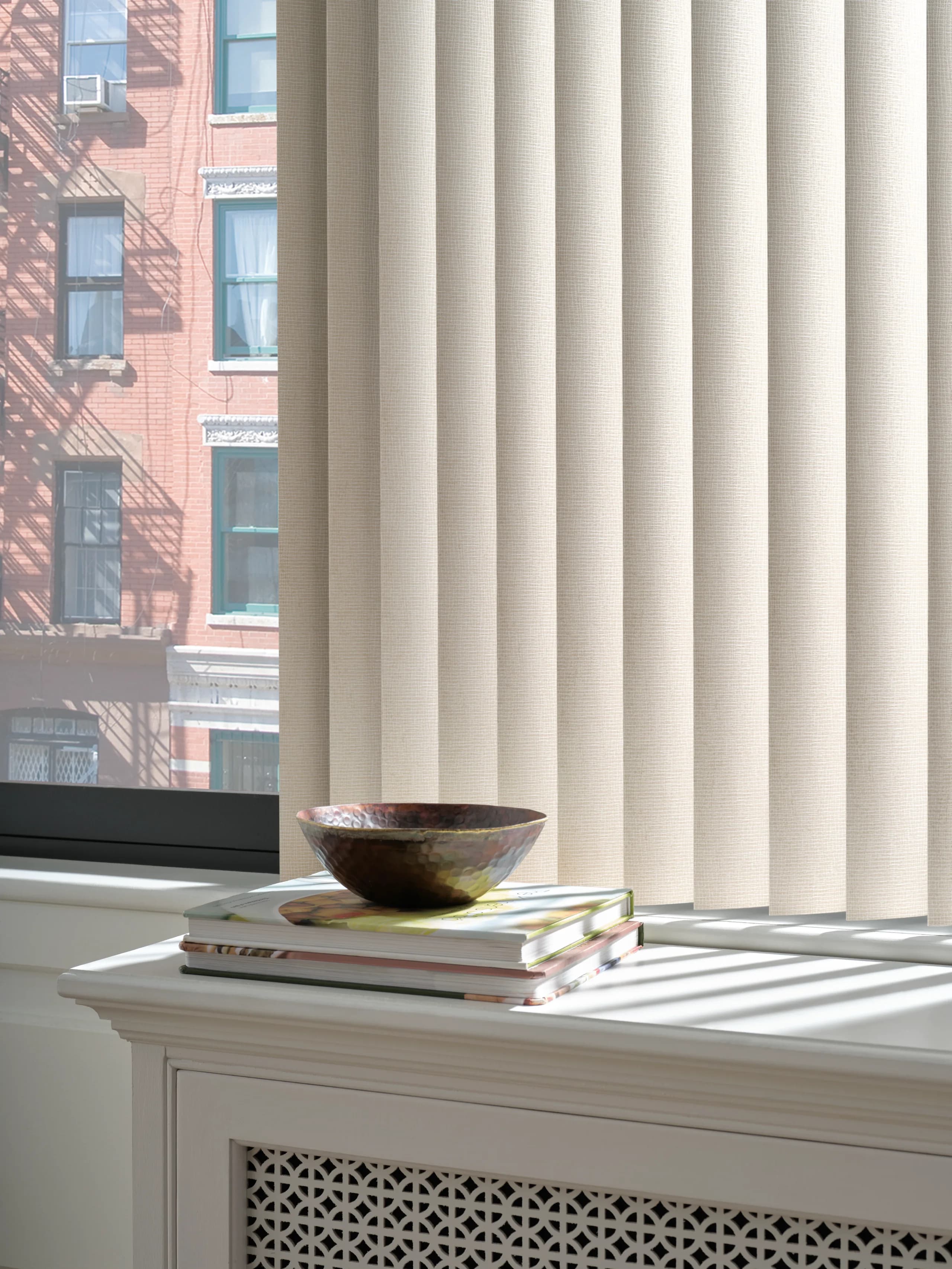 A close view of the texture on a gold toned vinyl louver from Hunter Douglas Somner® Custom Vertical Blinds.