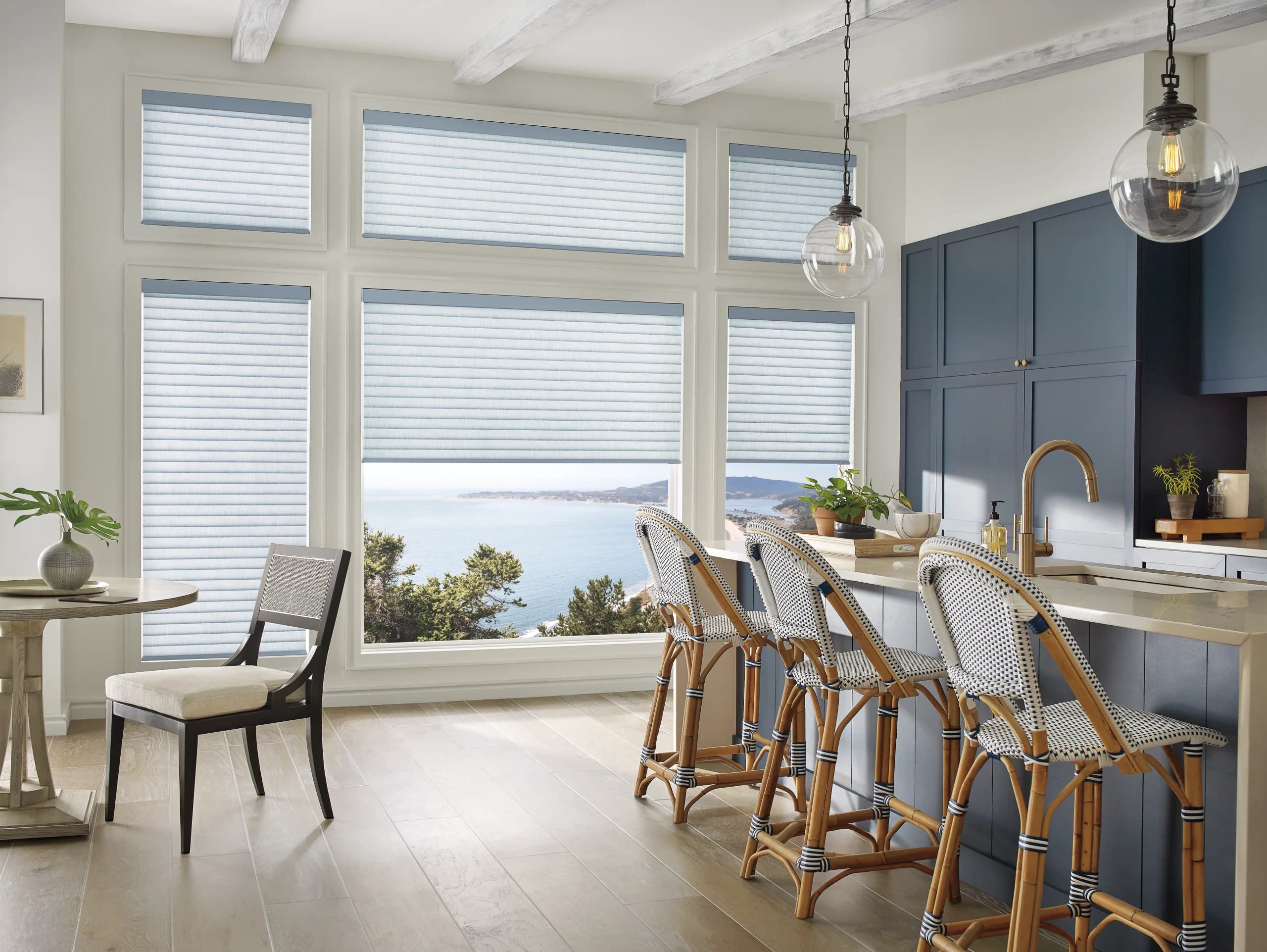 Hunter Douglas Sonnette® Cellular Roller Shades covering the windows of a bright kitchen.