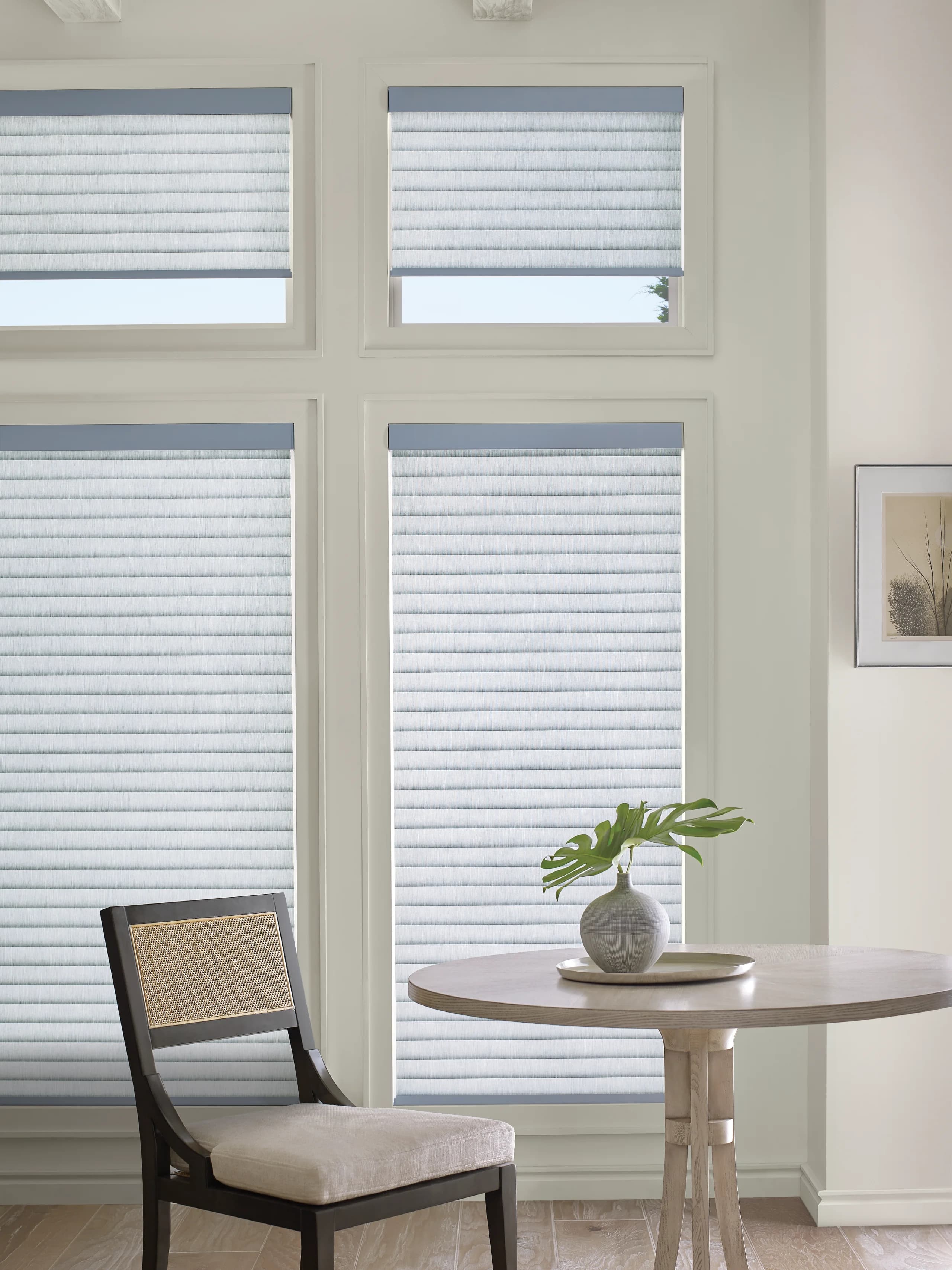 Hunter Douglas Sonnette® Cellular Roller Shades over a kitchen table, the cellular fabric diffusing midday sun.