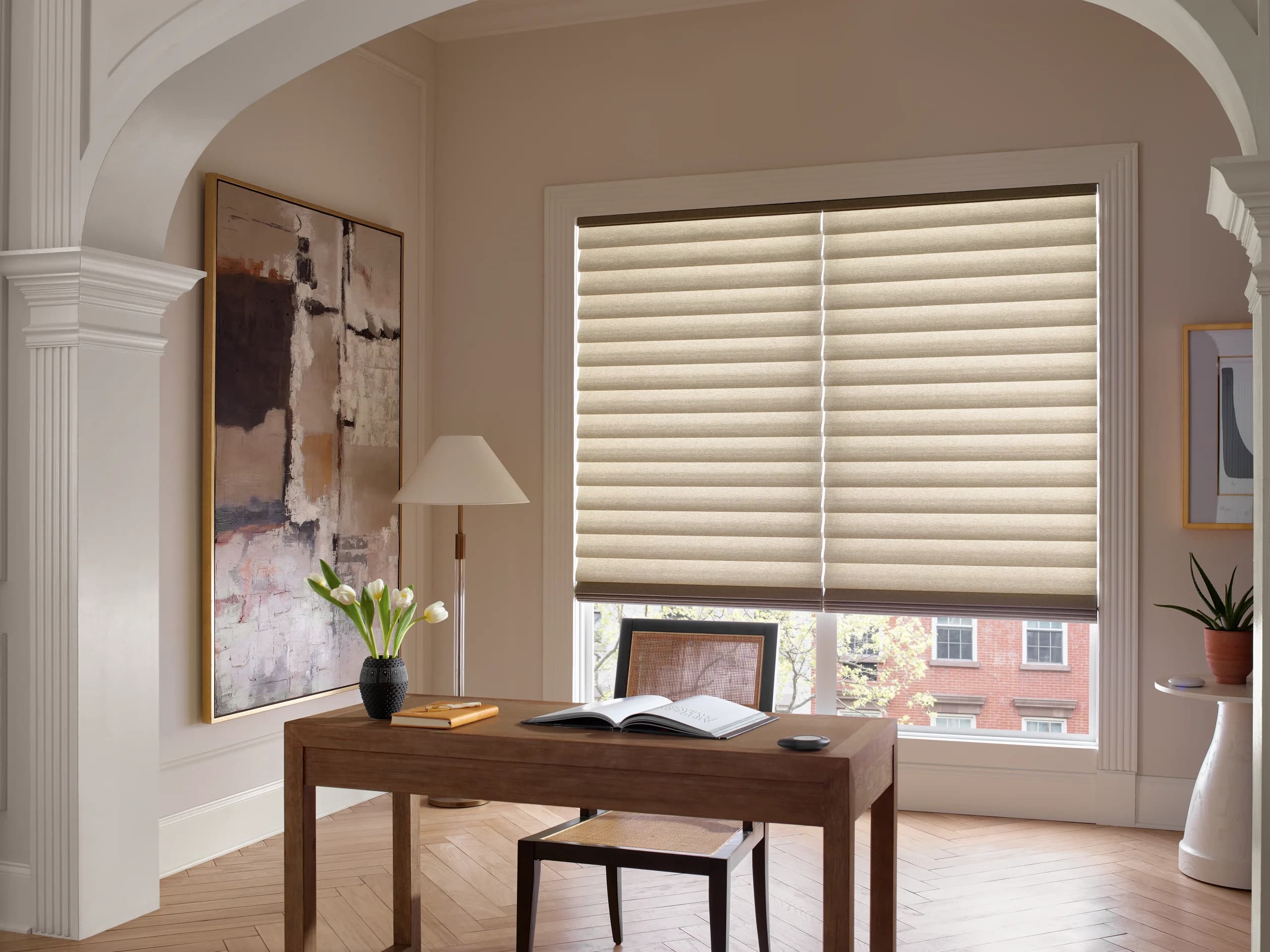 Hunter Douglas Vignette® Modern Roman Shades in a light-filtering fabric at an office window.