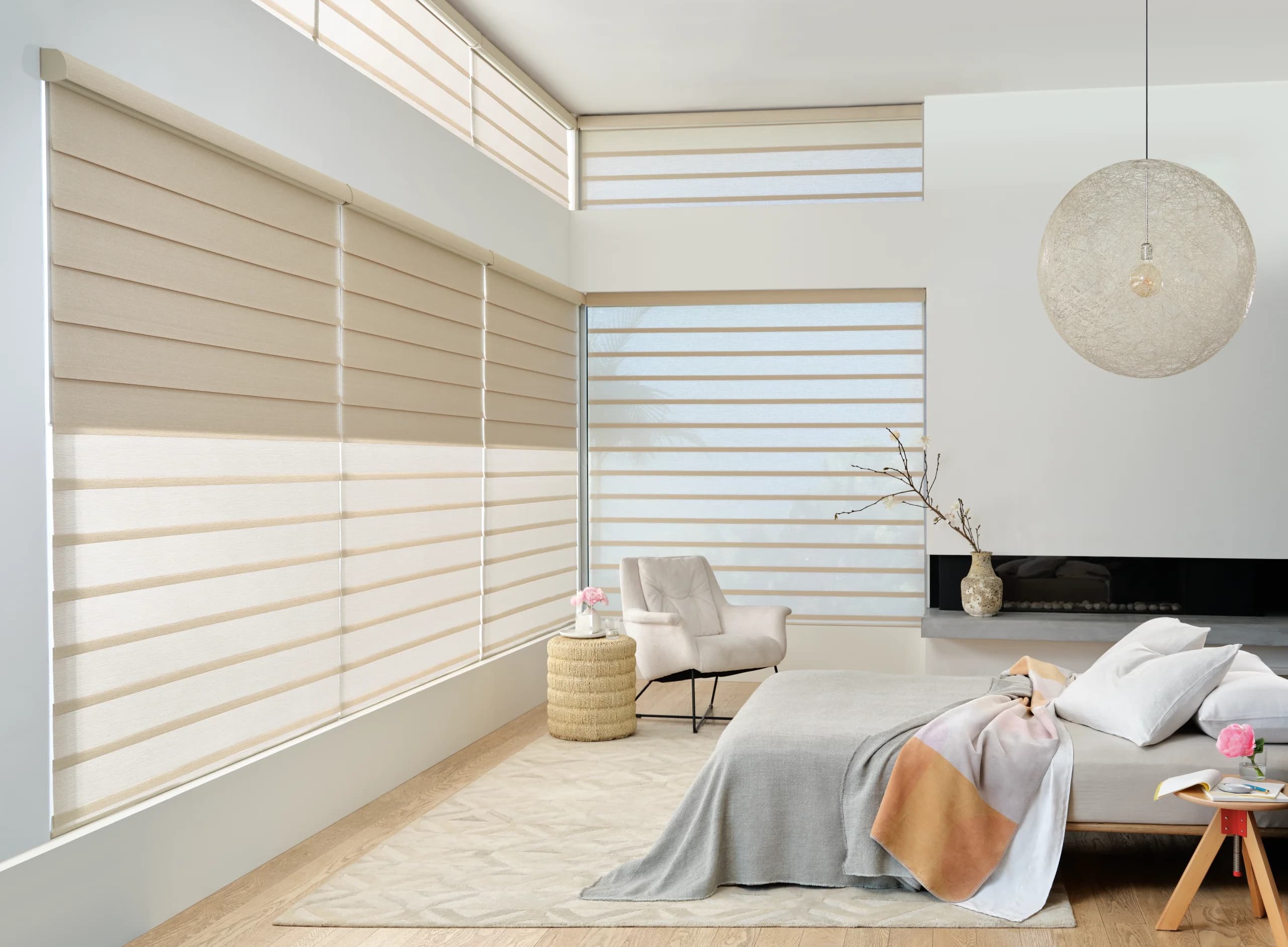 Hunter Douglas Vignette® Modern Roman Shades in a flat fold across a bedroom window.