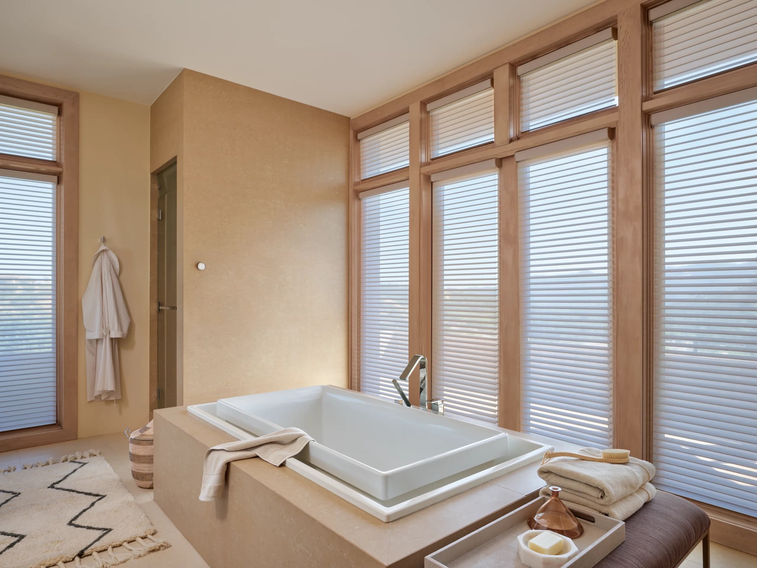 Hunter Douglas Silhouette® Window Shadings filtering daylight over a freestanding tub in a calm New England bath, measured and installed by Window Fantasies.