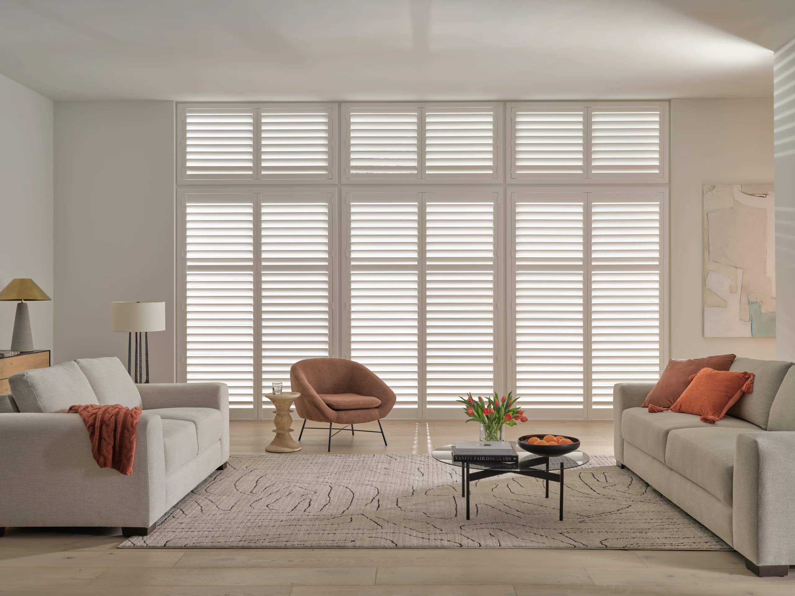 Hunter Douglas Palm Beach™ Polysatin™ Shutters with standard hinged panels in a living room.