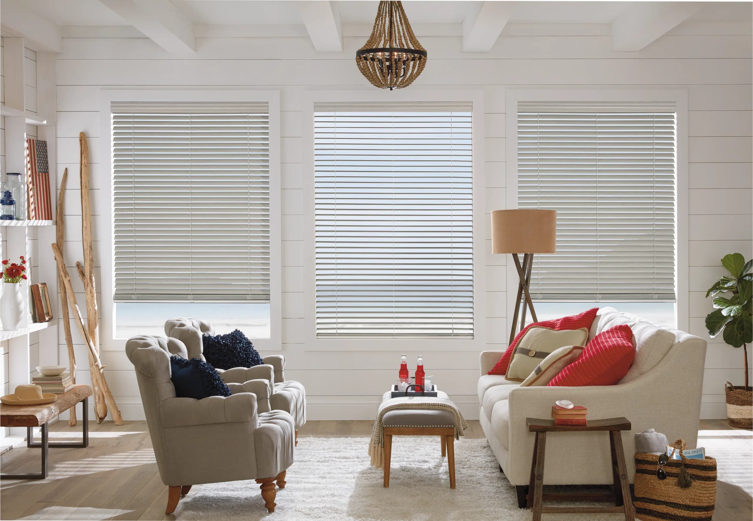 A bright kitchen with cellular honeycomb shades and someone reading nearby.