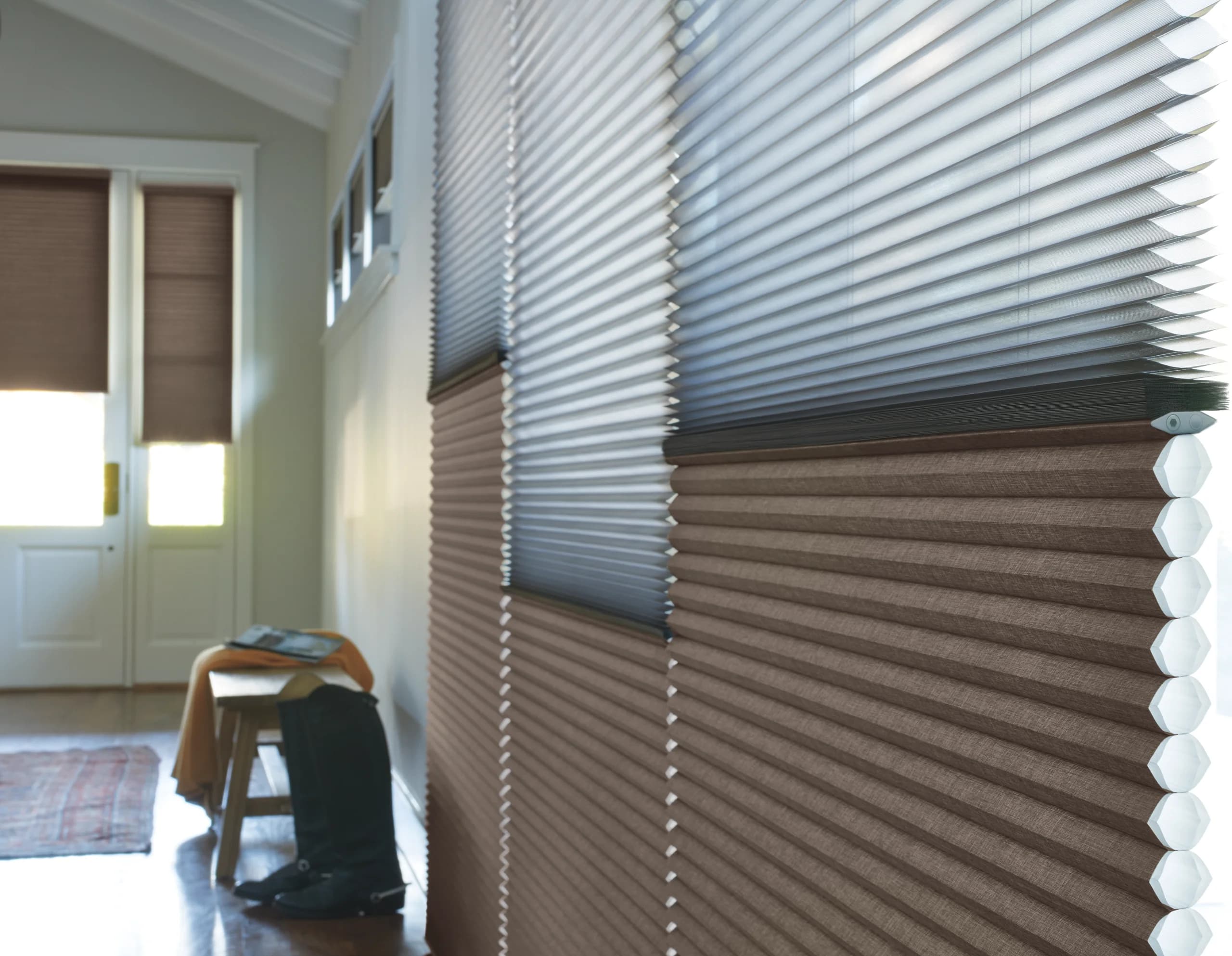 Hands holding a Hunter Douglas fabric sample during an in-home consultation.