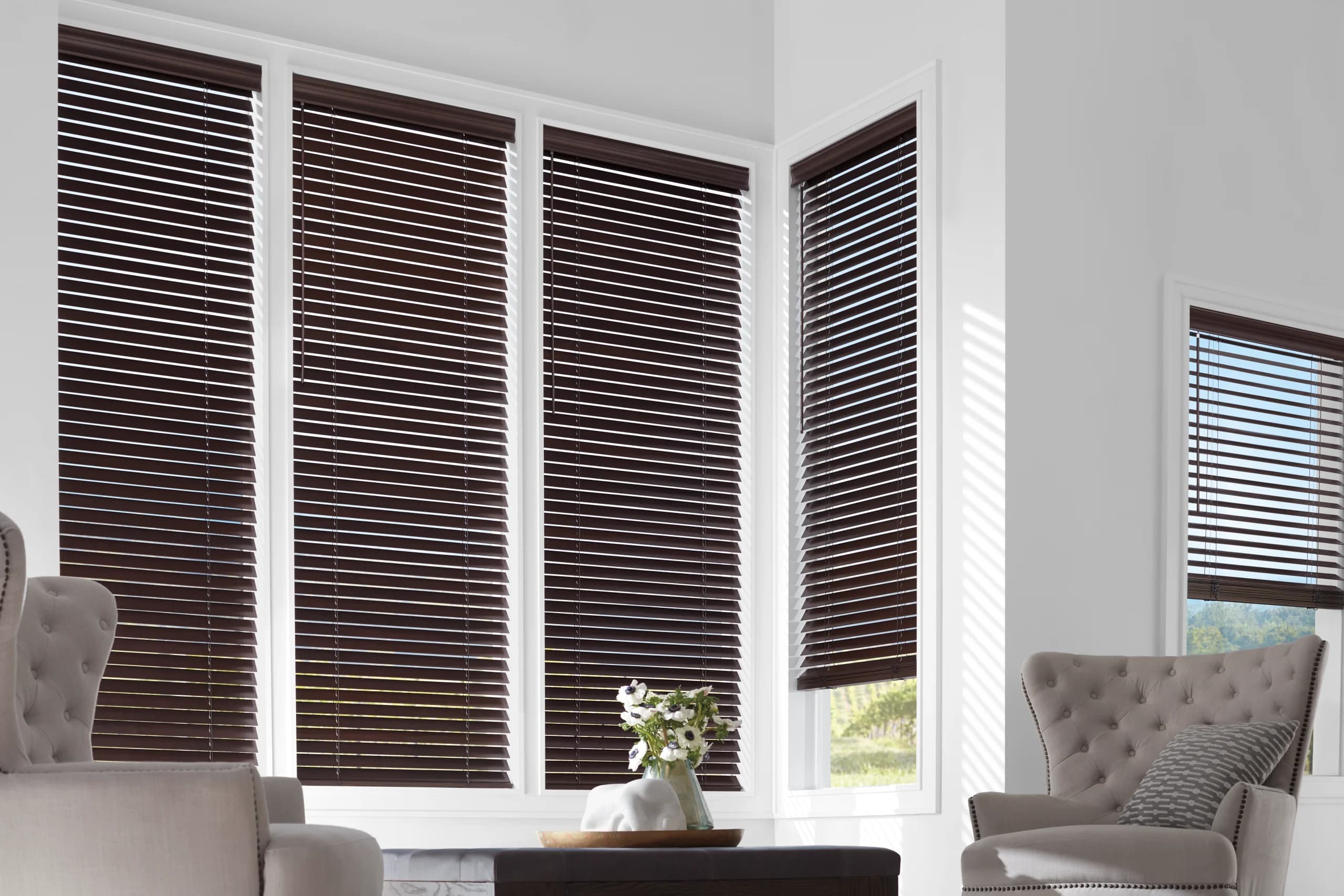 Warm wood blinds installed cleanly over a fireplace.