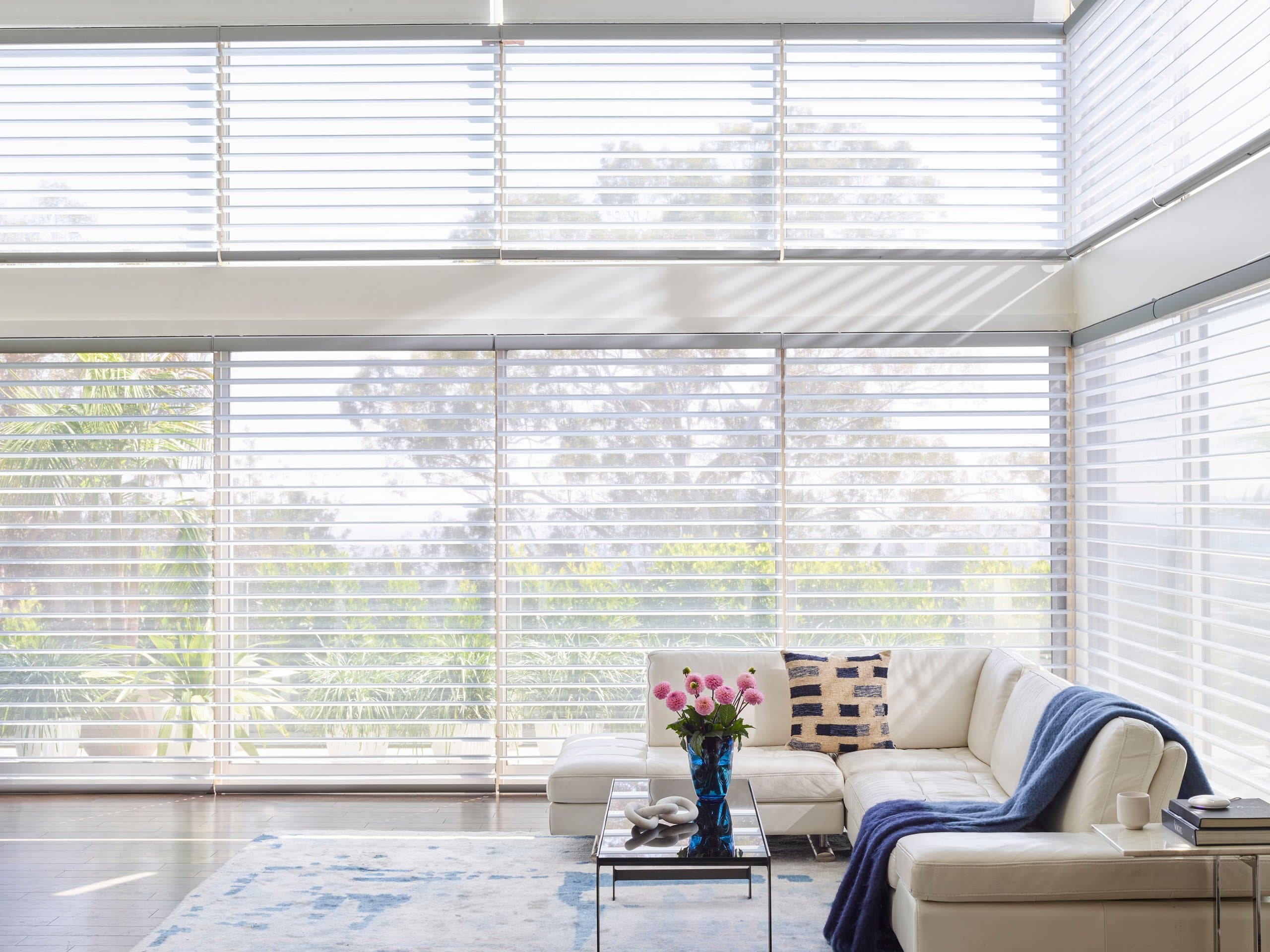 Custom Hunter Douglas Silhouette® Window Shadings softening the light across a bay window in a New England living room, measured and installed by Window Fantasies.