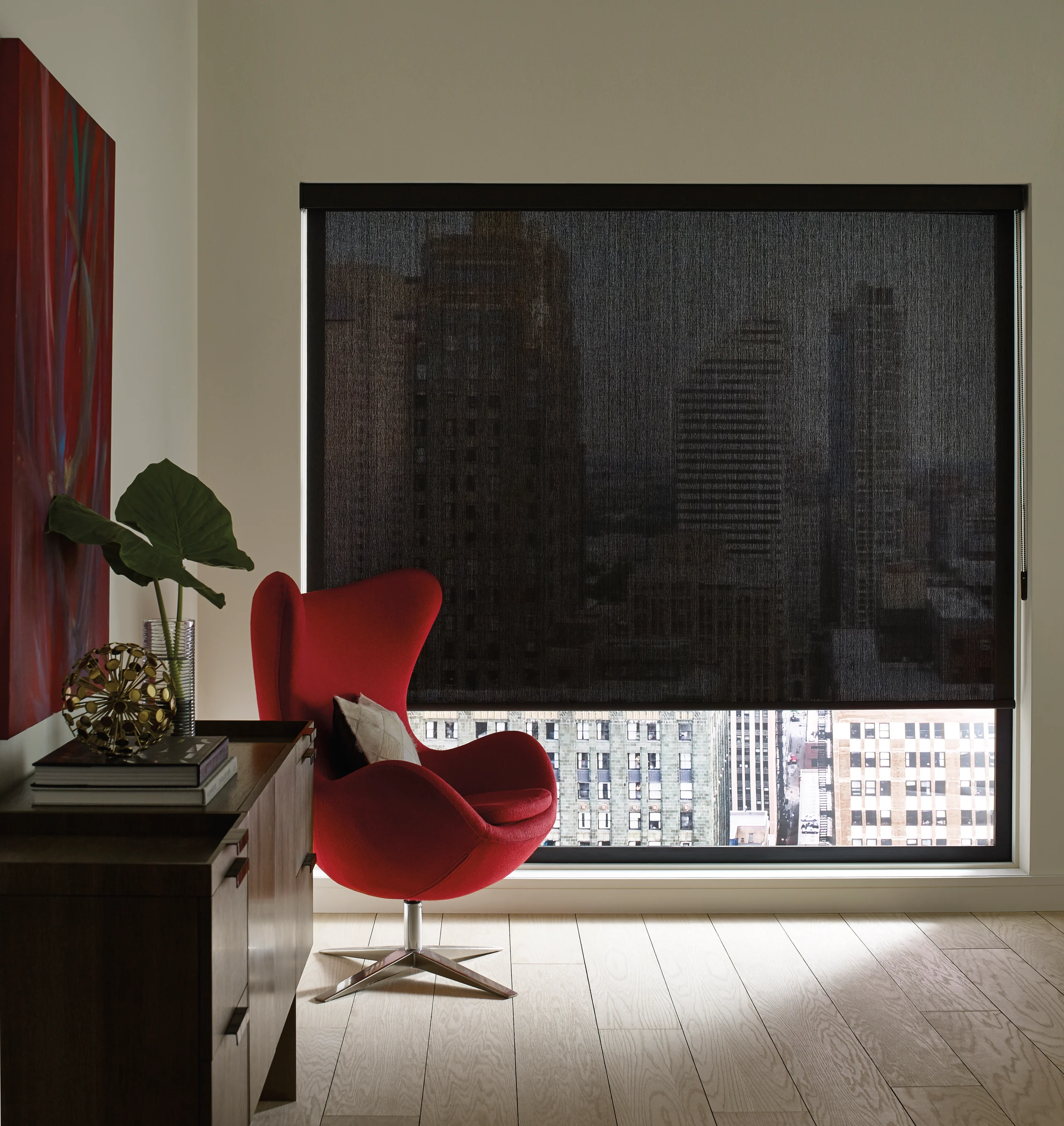 Hunter Douglas Designer Roller Shades filtering sunlight over a desk of fabric sample books in Jim's Salem office.