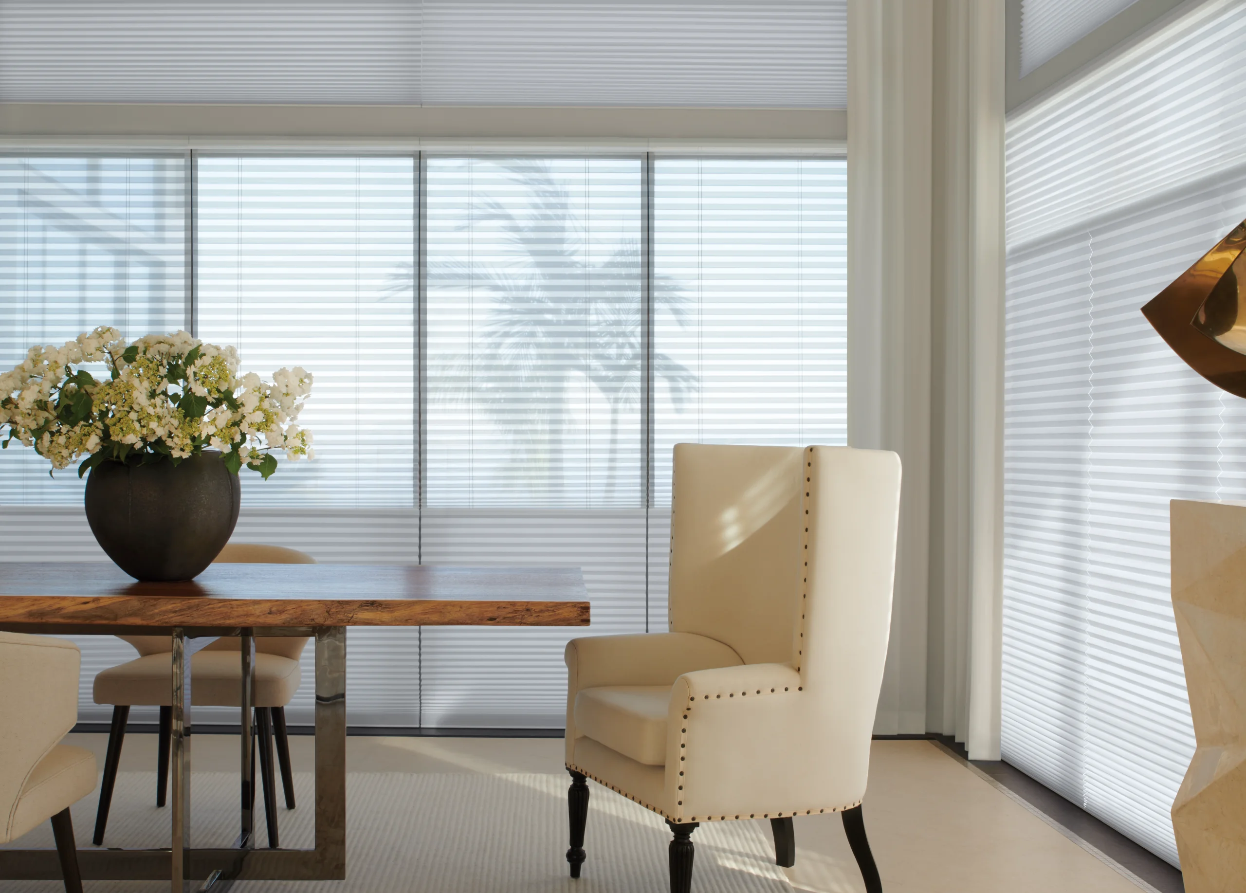 An elegant New England living room layered with sheer shades and drapery in morning light.