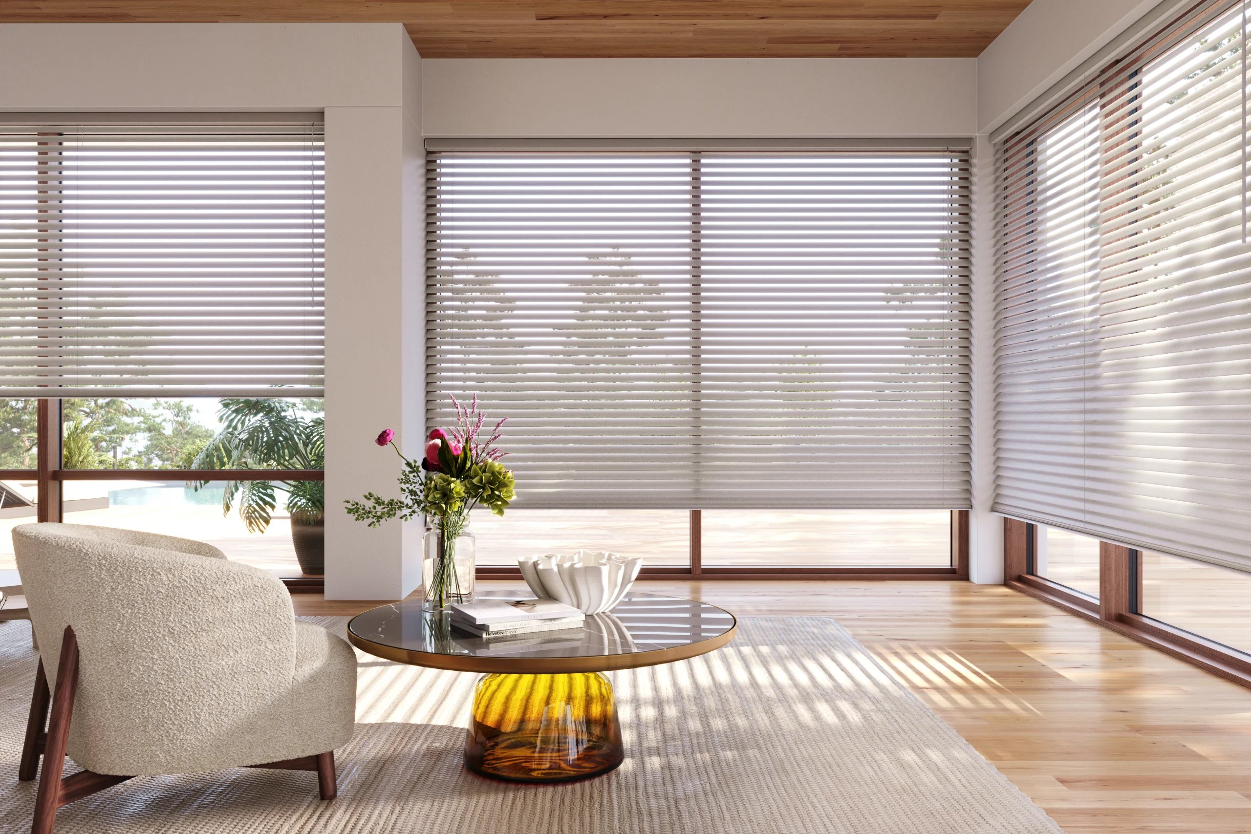 Hunter Douglas Aria™ Soft Blinds diffusing daylight across a wall of windows in a modern living room.
