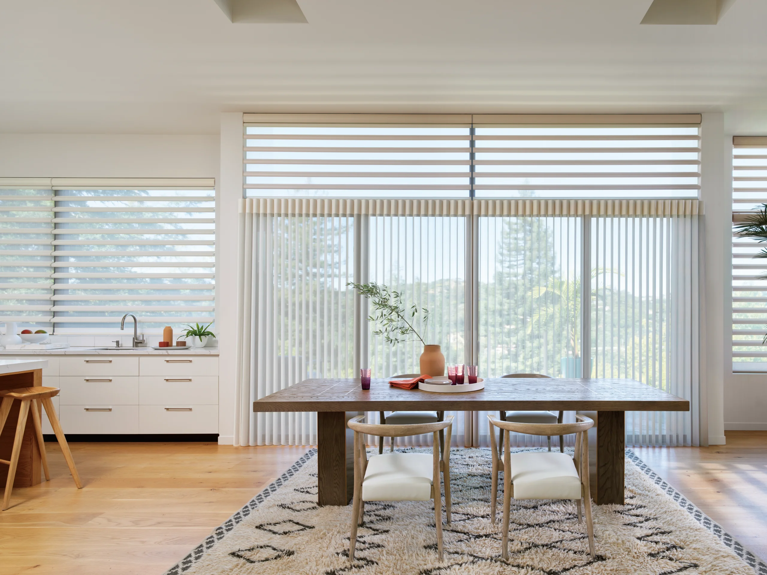 Hunter Douglas Pirouette® Window Shadings softening daylight over a kitchen window.