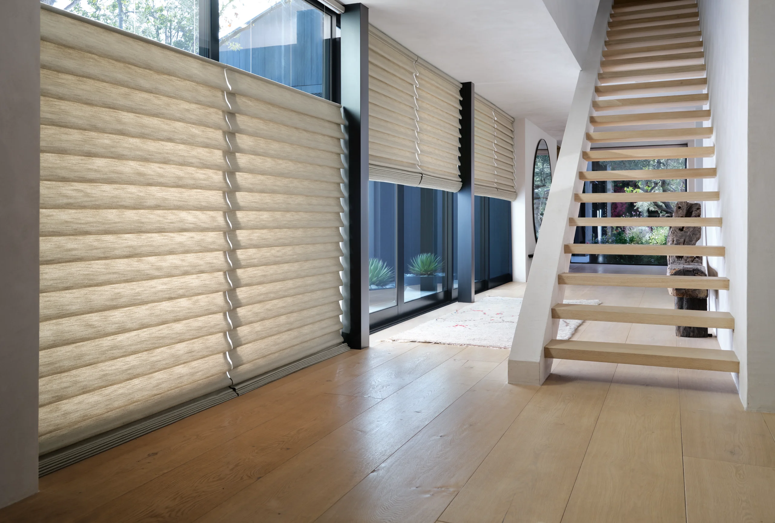 Hunter Douglas Vignette® Modern Roman Shades in a stacking style at a hallway stairwell window.